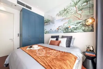 Stylish bedroom with blue wardrobe and tropical wall mural