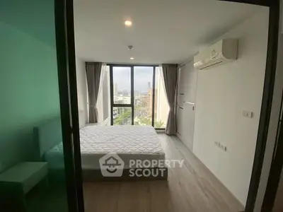 Modern bedroom with large windows and city view, featuring air conditioning and minimalist design.