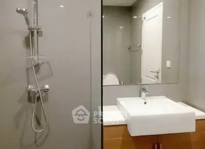 Modern bathroom with sleek shower and stylish sink in contemporary design.