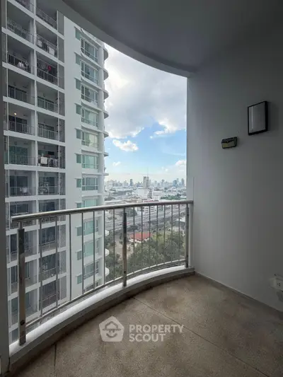 Spacious balcony with stunning city view in modern high-rise apartment