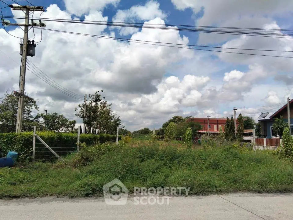 Scenic vacant land with lush greenery and clear skies, ideal for development or investment opportunities.