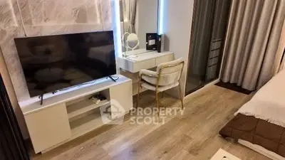 Modern bedroom with TV and stylish vanity desk