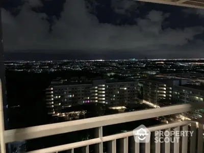 Stunning night cityscape view from high-rise balcony overlooking urban skyline.