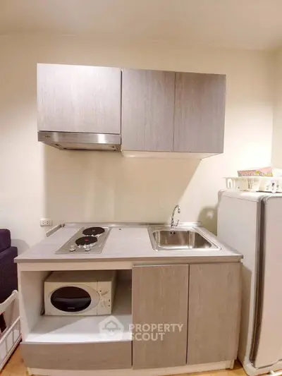 Compact modern kitchen with sleek cabinetry and integrated appliances