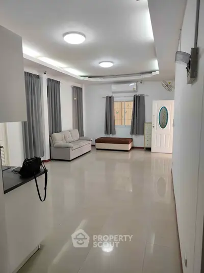 Spacious modern living room with sleek design and ample natural light.