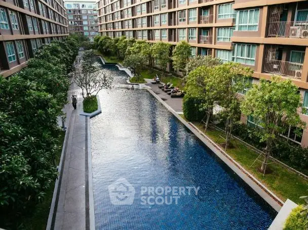Luxurious apartment complex with stunning pool and lush greenery