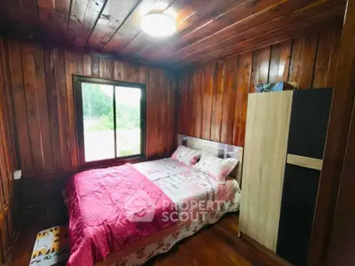 Cozy wooden bedroom with large window and modern wardrobe
