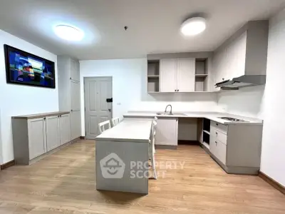 Modern kitchen with sleek cabinetry and open layout in a stylish apartment.
