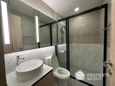 Modern bathroom with glass shower enclosure and stylish sink