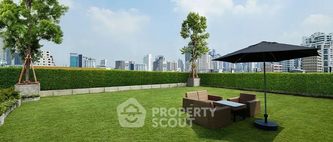 Spacious rooftop garden with city skyline view, featuring outdoor seating and lush greenery.