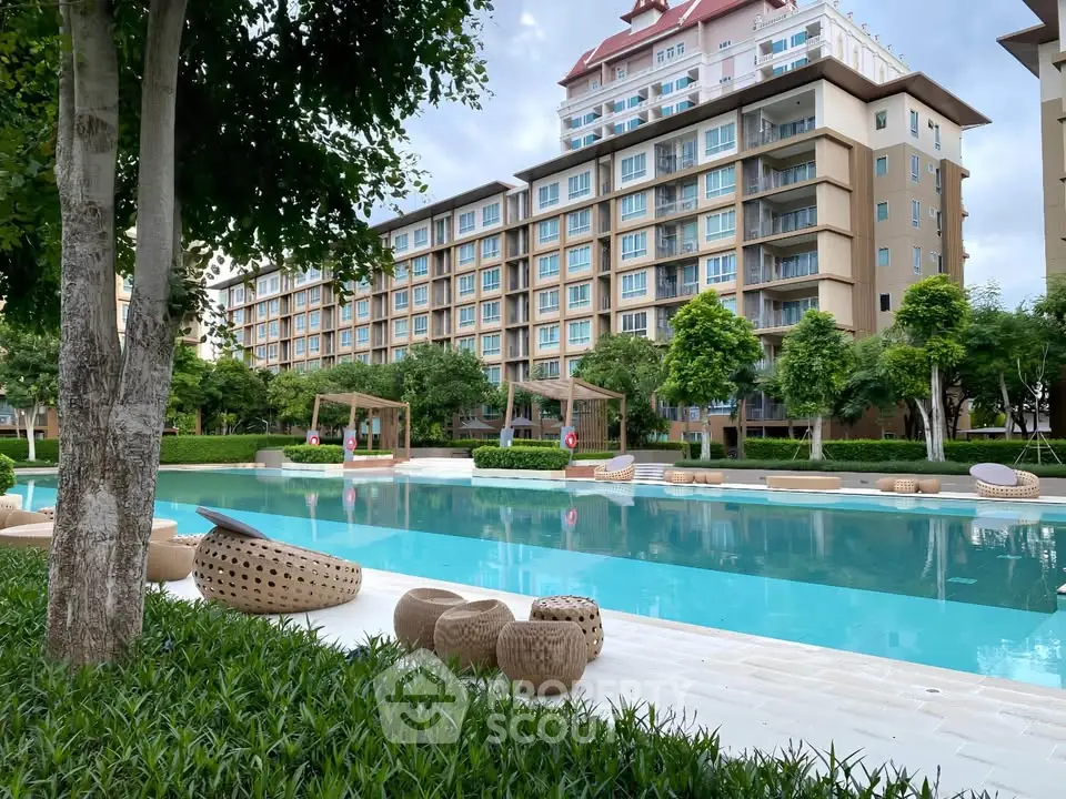 Luxurious apartment complex with stunning pool and lush greenery