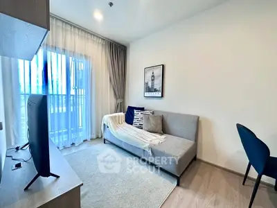 Modern living room with cozy sofa and large window, perfect for relaxation.