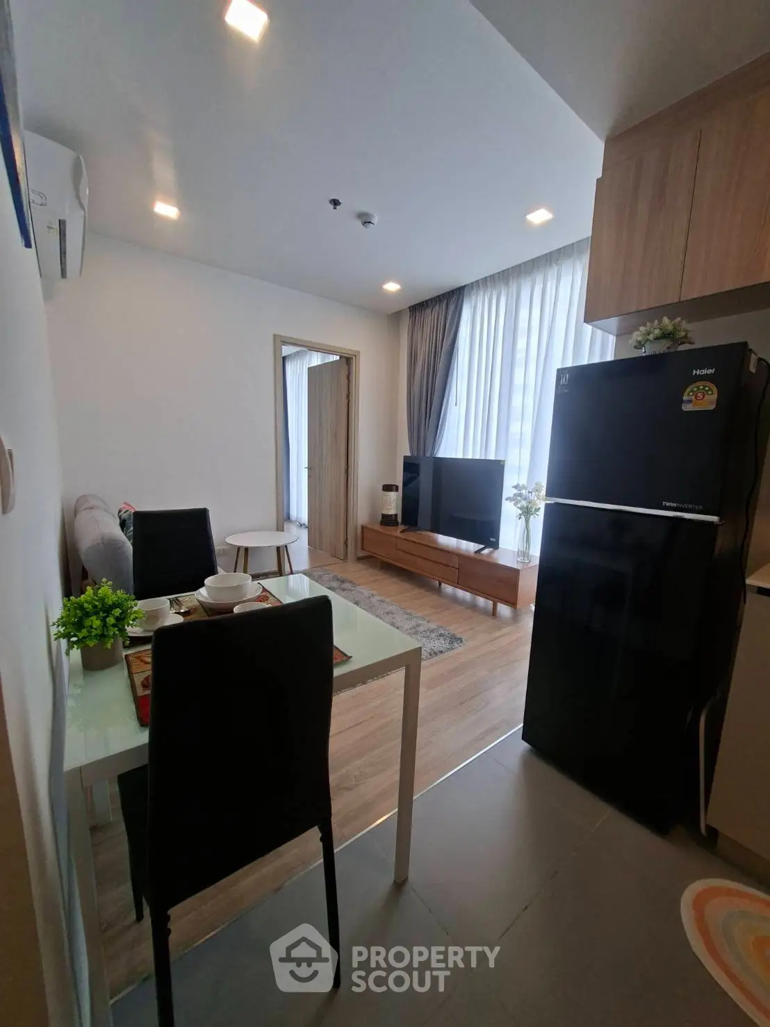 Modern living room with dining area and sleek kitchen appliances