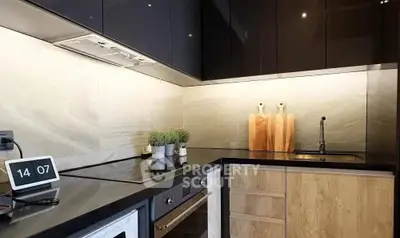 Modern kitchen with sleek cabinets and built-in oven, featuring a stylish backsplash.