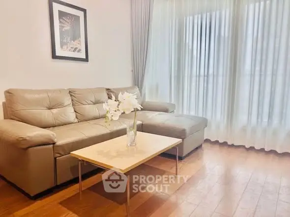 Elegant living room with cozy beige sofa and chic decor, perfect for relaxation and entertaining.
