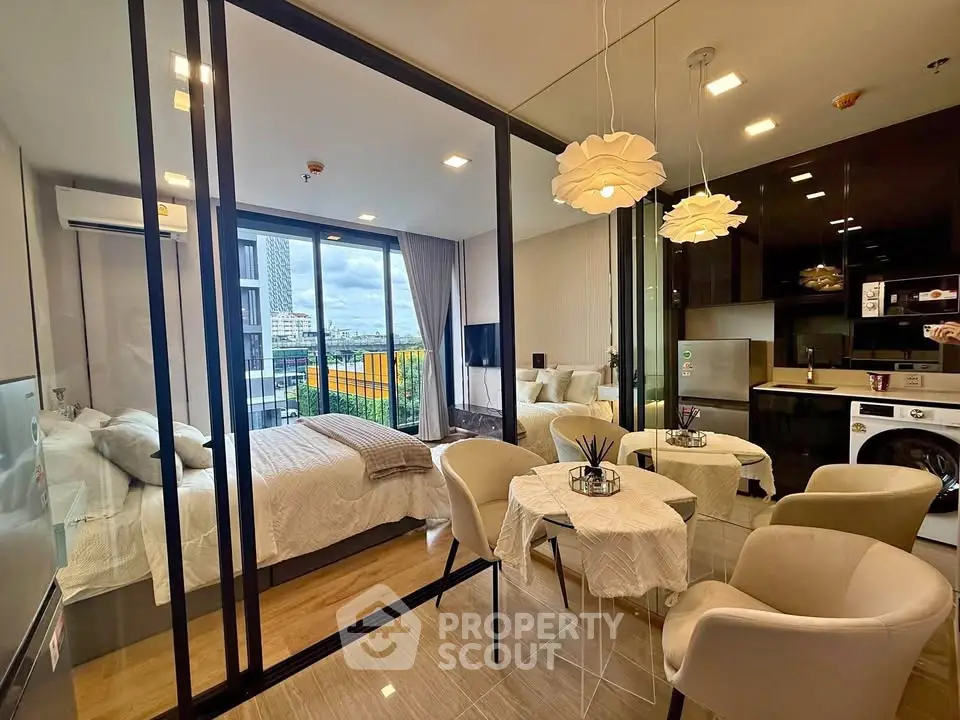 Modern studio apartment with glass partition, stylish kitchen, and city view balcony.