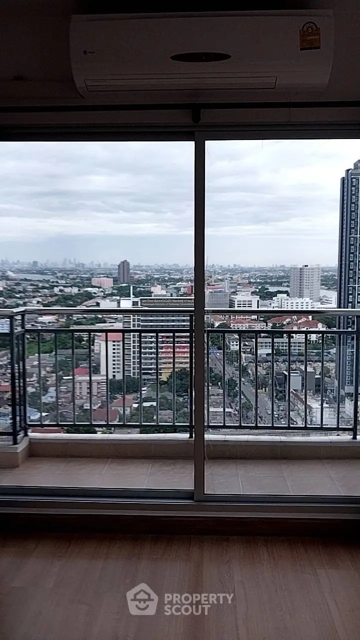 Stunning high-rise apartment with panoramic city view from the balcony, perfect for urban living.