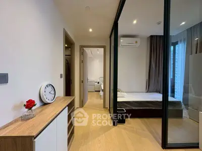 Modern bedroom with glass partition and stylish wooden flooring