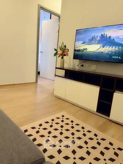 Modern living room with stylish decor and wall-mounted TV, showcasing a cozy and inviting atmosphere.