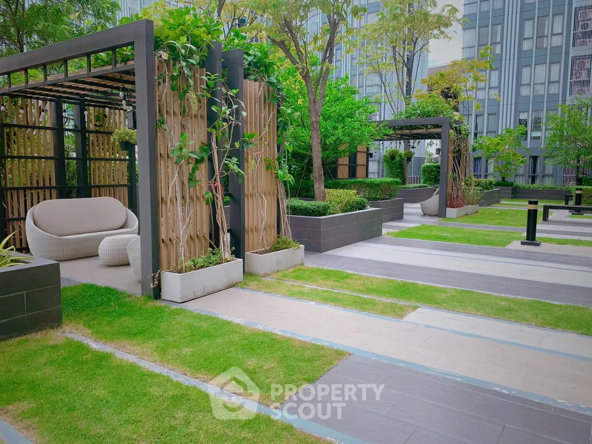 Luxurious garden area with modern seating and lush greenery in urban setting.