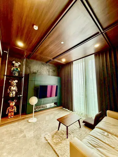 Luxurious living room with modern decor, plush seating, and floor-to-ceiling windows for natural light.