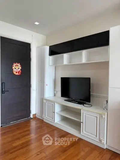 Modern living room with sleek TV cabinet and wooden flooring