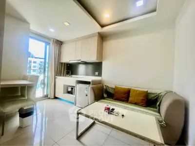 Modern living room with kitchenette and natural light in urban apartment
