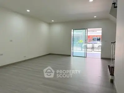 Spacious modern living room with large windows and sleek flooring