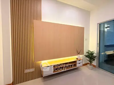 Modern living room with stylish wooden paneling and sleek storage unit