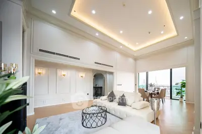 Luxurious living room with high ceilings and elegant decor, featuring a spacious open layout and stunning city view.