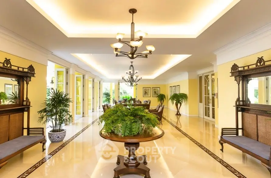 Luxurious entrance with elegant decor and lush greenery, showcasing a grand and inviting ambiance.
