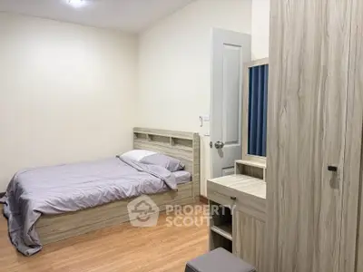 Cozy bedroom with wooden furniture and soft lighting, perfect for relaxation.