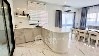 Luxurious modern kitchen with marble countertops and elegant dining area