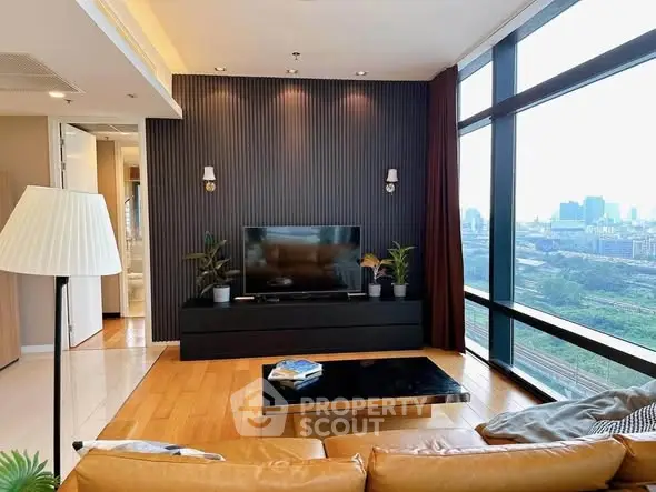 Modern living room with city view, sleek decor, and large windows.