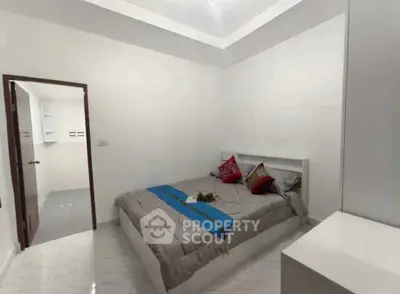 Modern bedroom with stylish decor and ensuite bathroom in a contemporary home.