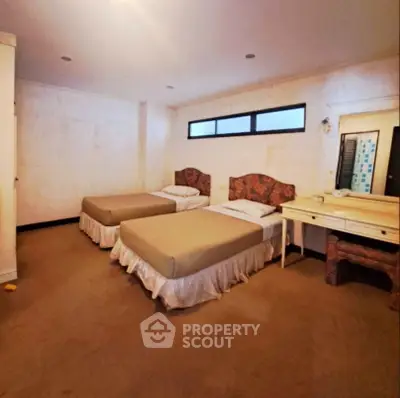 Spacious bedroom with modern decor and ample natural light