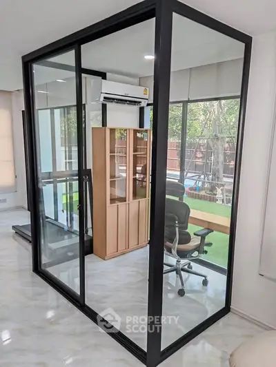 Modern glass-enclosed study room with sleek design and natural light