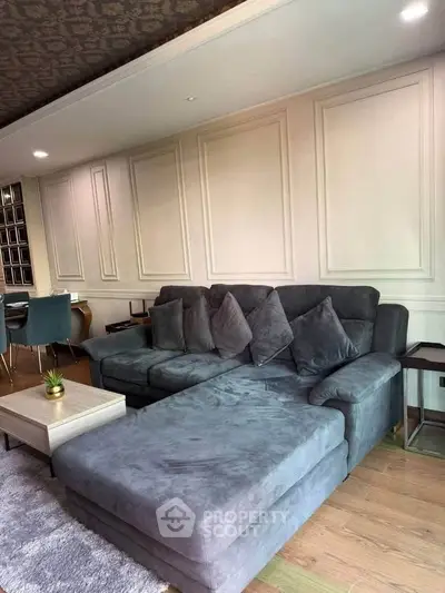 Spacious living room with elegant gray sectional sofa and stylish decor