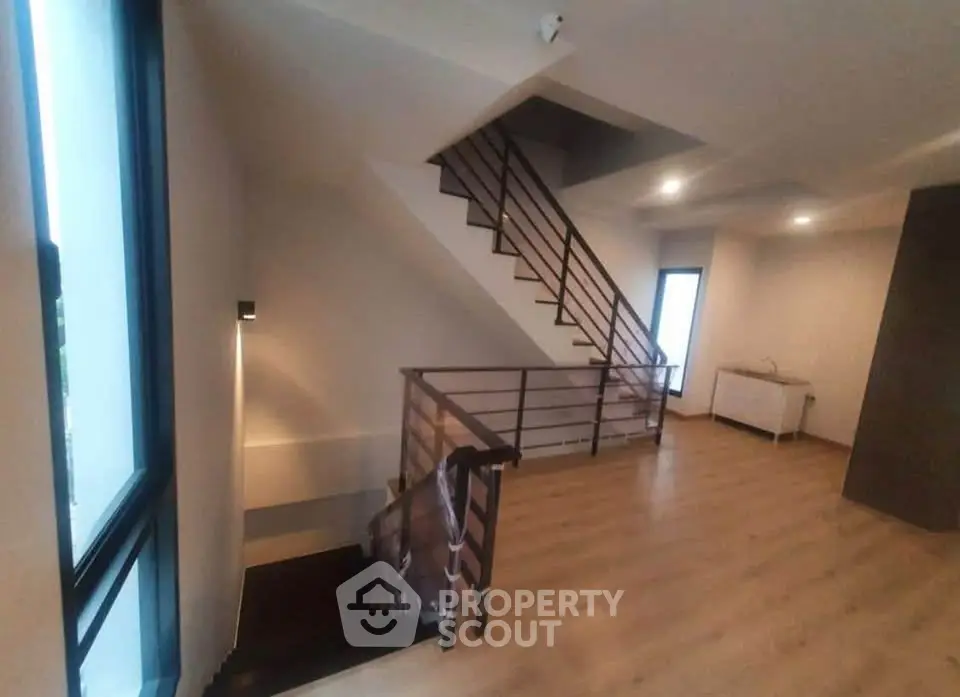 Modern interior with wooden flooring and sleek staircase in a contemporary home