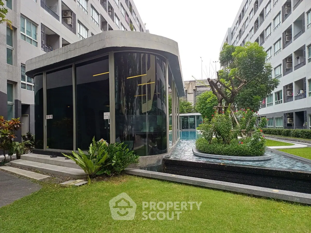 Modern apartment complex with lush garden and sleek architecture