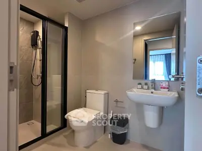 Modern bathroom with sleek shower and elegant fixtures in a contemporary apartment.