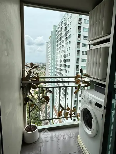 High-rise apartment balcony with washing machine and city view