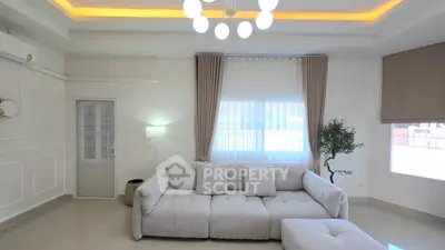 Spacious modern living room with elegant lighting and plush sofa, perfect for relaxation and entertaining.