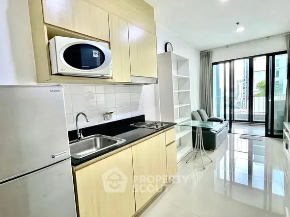 Modern kitchen with sleek appliances and open layout in a bright apartment
