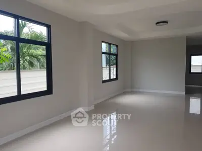 Spacious and bright living room with large windows and modern design.