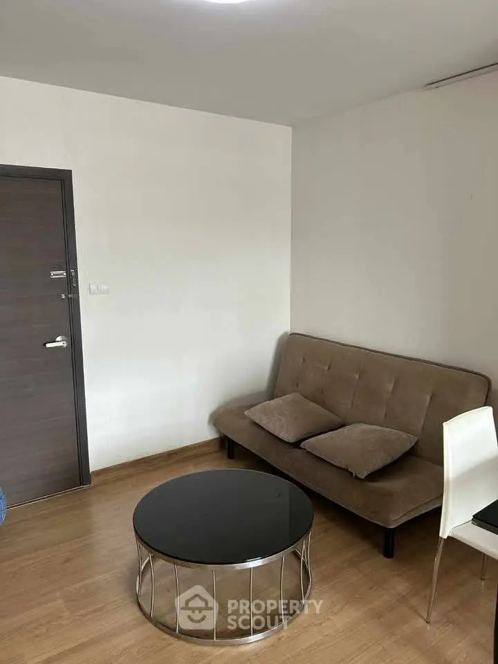 Cozy living room with modern sofa and sleek coffee table, perfect for relaxation.