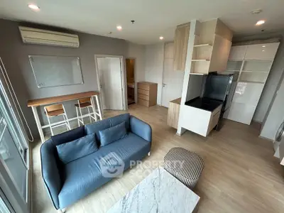 Modern living room with stylish furniture and open kitchen layout in a contemporary apartment.