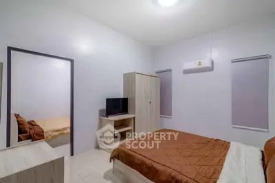 Cozy bedroom with modern air conditioning and neutral decor, perfect for relaxation.
