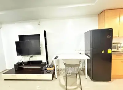 Modern living space with sleek TV setup and compact dining area