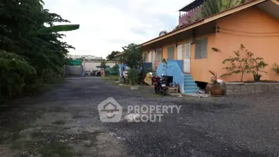 Charming single-story home with vibrant exterior and spacious outdoor area, perfect for family living.